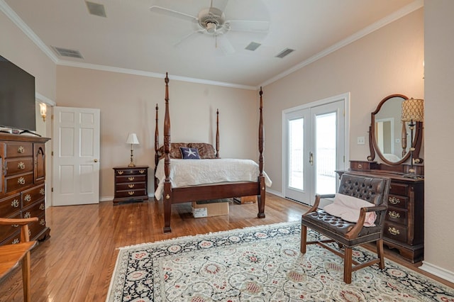 bedroom with access to outside, crown molding, light hardwood / wood-style flooring, ceiling fan, and a fireplace