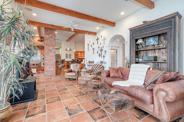 living room with beam ceiling, ornate columns, and ceiling fan