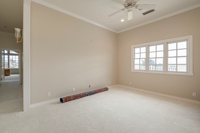 carpeted spare room featuring ceiling fan and crown molding