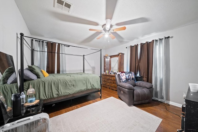 1101 Barnes Ave, Big Spring, TX 79720 - bedroom featuring wood finished floors, ceiling fan, and a textured ceiling