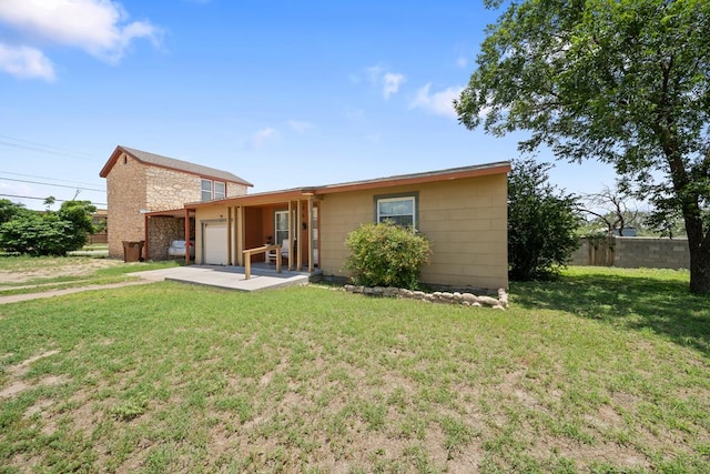 1101 Barnes Ave, Big Spring, TX 79720 - back of house featuring a garage, stone siding, and driveway