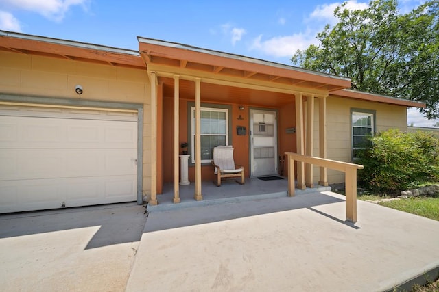 1101 Barnes Ave, Big Spring, TX 79720 - view of front of property with covered porch, an attached garage, concrete driveway, and concrete block siding