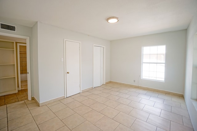 404W Jax Ave, Midland, TX 79701 - unfurnished bedroom featuring light tile patterned floors and a closet