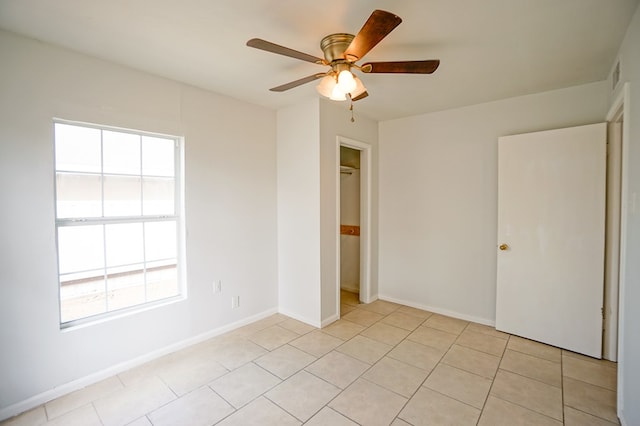 404W Jax Ave, Midland, TX 79701 - unfurnished bedroom with multiple windows, light tile patterned floors, and ceiling fan