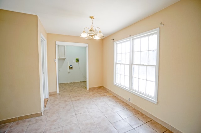 404W Jax Ave, Midland, TX 79701 - unfurnished room with a chandelier and light tile patterned flooring