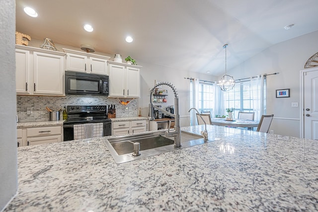 kitchen featuring black appliances, a chandelier, decorative backsplash, a sink, and vaulted ceiling