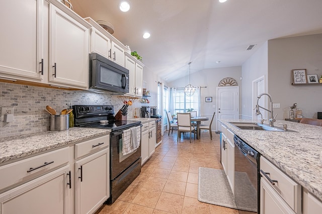 kitchen featuring black appliances, a sink, backsplash, vaulted ceiling, and light tile patterned flooring