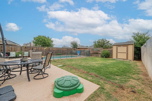 view of yard with a storage unit, a patio area, and an outbuilding