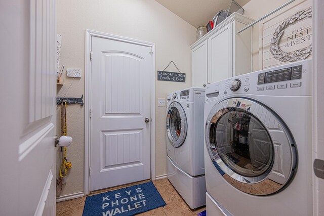 washroom with separate washer and dryer, cabinet space, and light tile patterned flooring