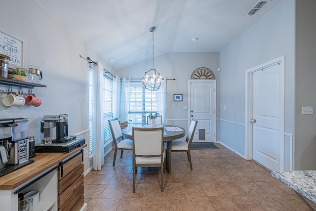 dining room featuring a chandelier and lofted ceiling