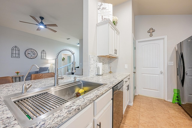 kitchen with a sink, dishwasher, white cabinets, backsplash, and light stone counters