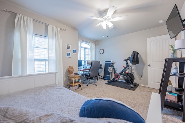 bedroom featuring carpet floors, an office area, and a ceiling fan