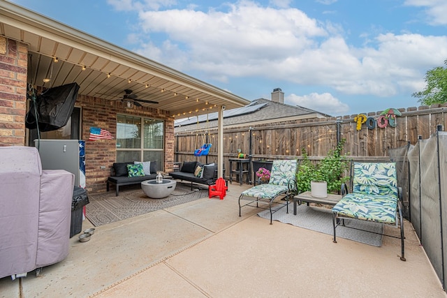 view of patio with ceiling fan, an outdoor living space, and a fenced backyard