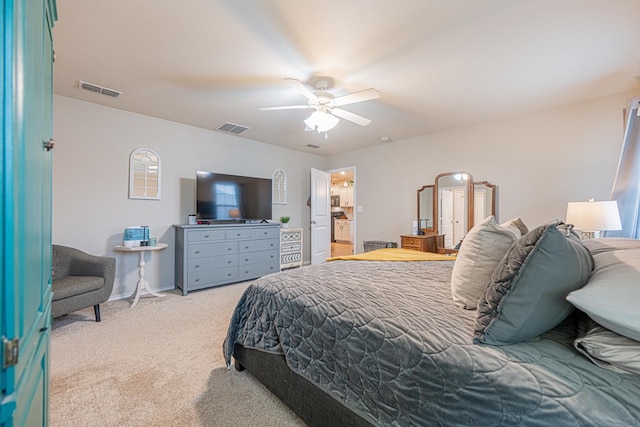 bedroom featuring light colored carpet, ceiling fan, and baseboards