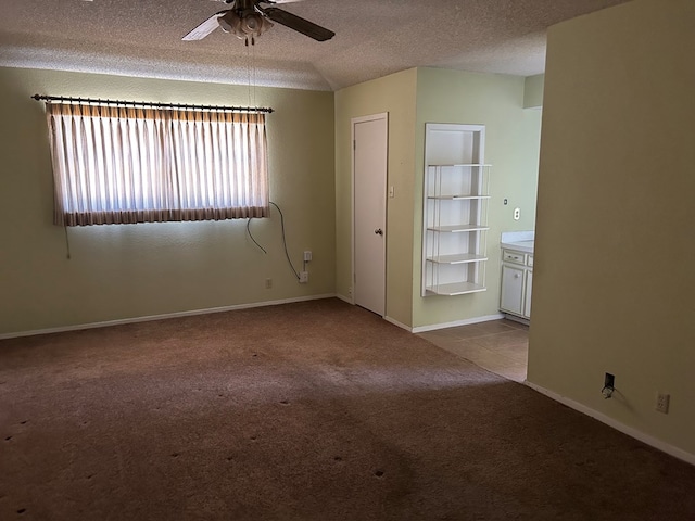 3210 Park Ln, Midland, TX 79701 - carpeted empty room with a ceiling fan, a textured ceiling, and baseboards