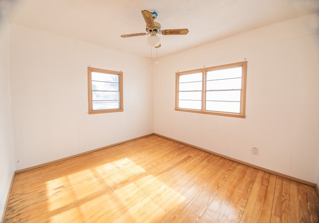 spare room featuring light wood-type flooring and ceiling fan