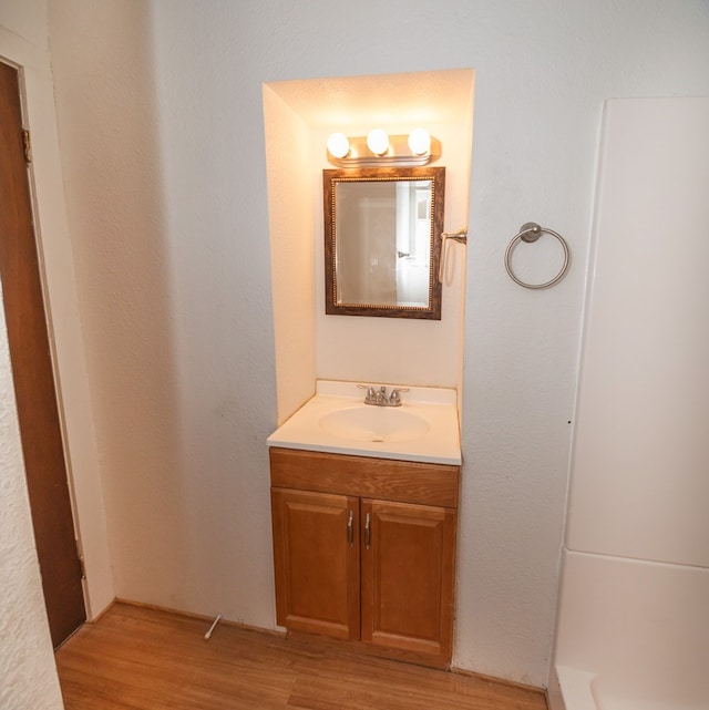 bathroom with hardwood / wood-style floors and vanity