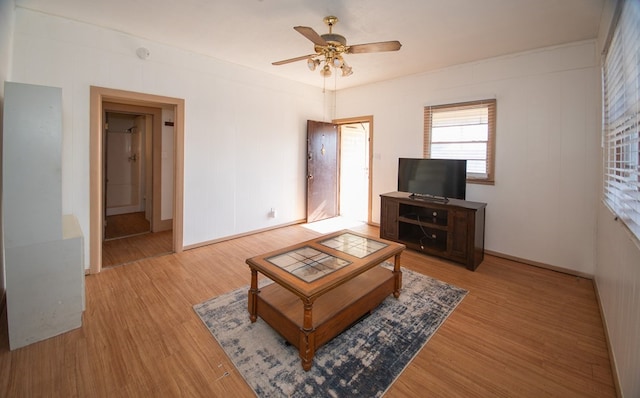 living room featuring wood-type flooring and ceiling fan