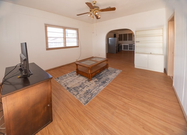 living room with ceiling fan and wood-type flooring