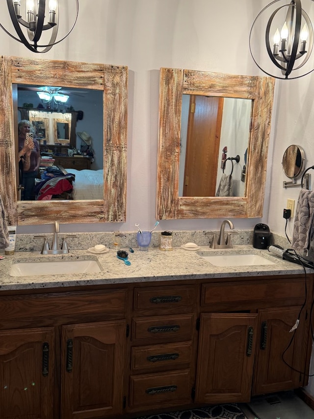 full bath featuring a sink, ensuite bath, and a chandelier