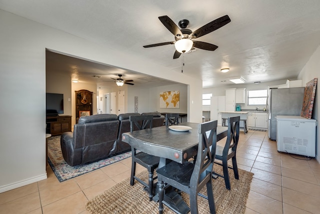 2724 E 11th St, Odessa, TX 79761 - dining room featuring light tile patterned floors, a ceiling fan, and baseboards