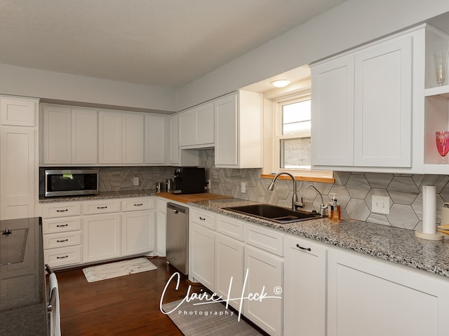 kitchen featuring white cabinetry, appliances with stainless steel finishes, and a sink