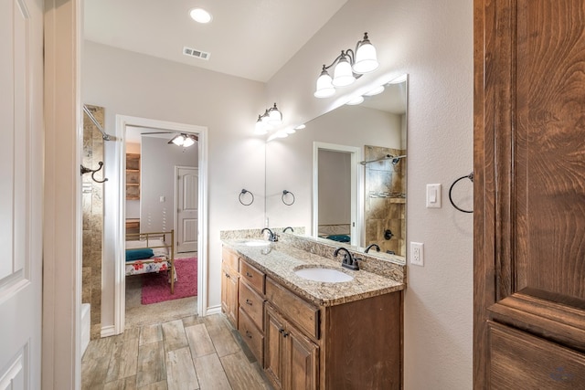 bathroom featuring a shower and vanity