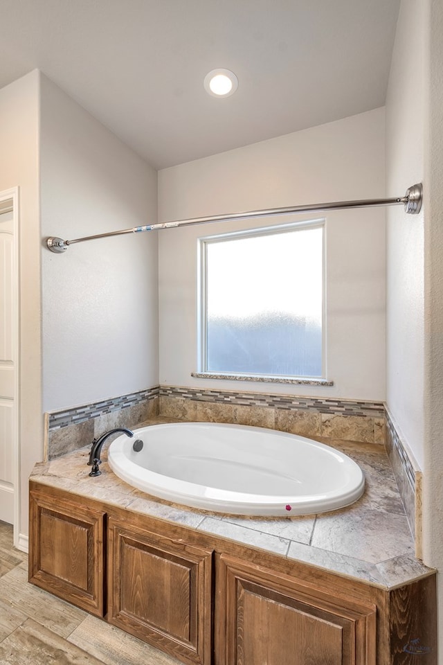 bathroom featuring hardwood / wood-style floors and a bathtub