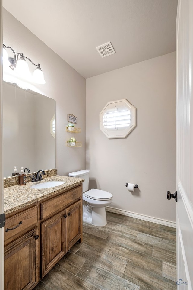 bathroom with toilet and vanity