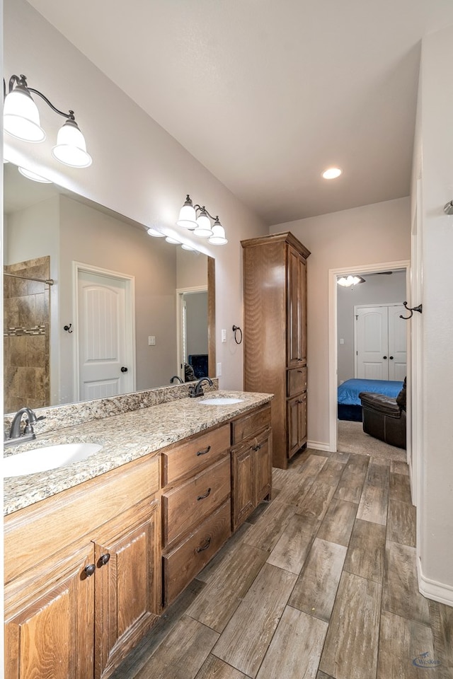 bathroom featuring walk in shower and vanity