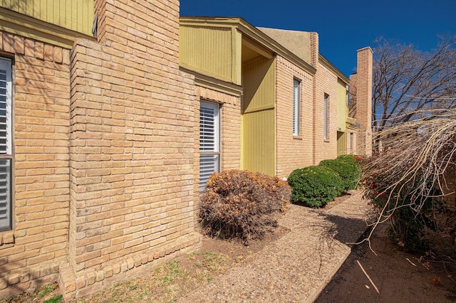 view of home's exterior with brick siding