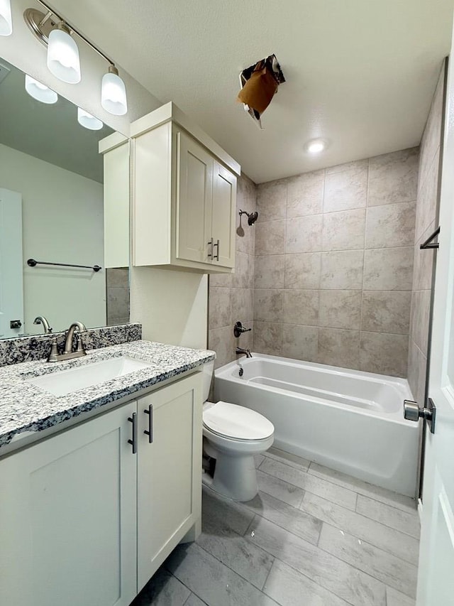 bathroom featuring vanity, toilet, and shower / bathtub combination