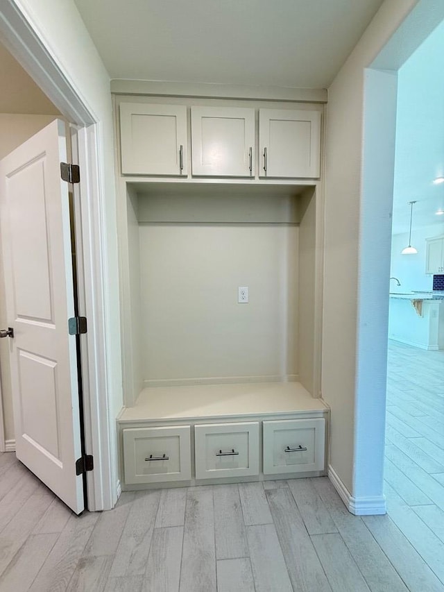 mudroom with wood tiled floor