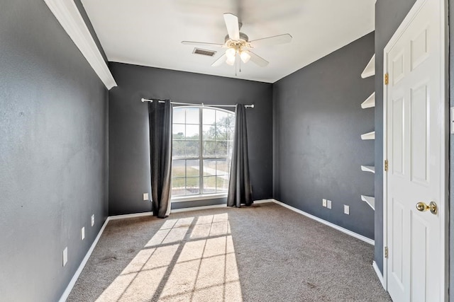 carpeted spare room featuring ceiling fan