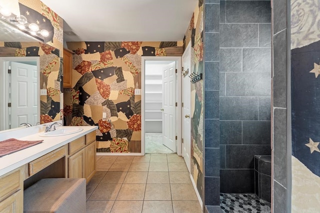 bathroom featuring tile patterned floors, vanity, and tiled shower