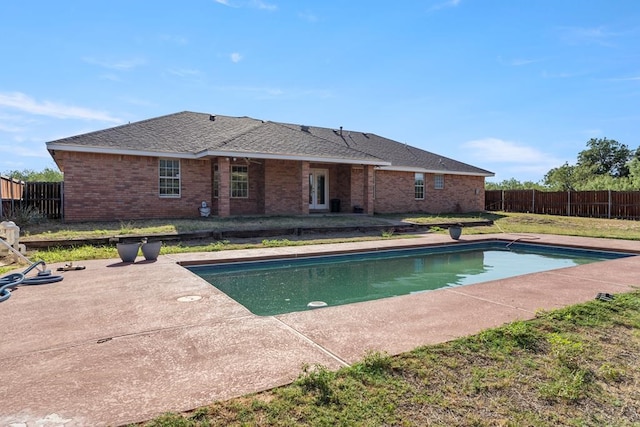 view of pool featuring a lawn and a patio area