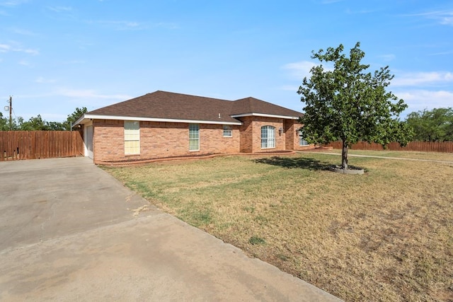 ranch-style home with a garage and a front lawn