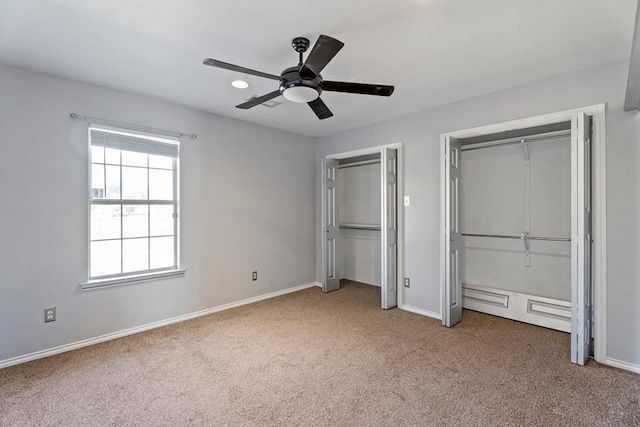 unfurnished bedroom featuring ceiling fan and carpet floors