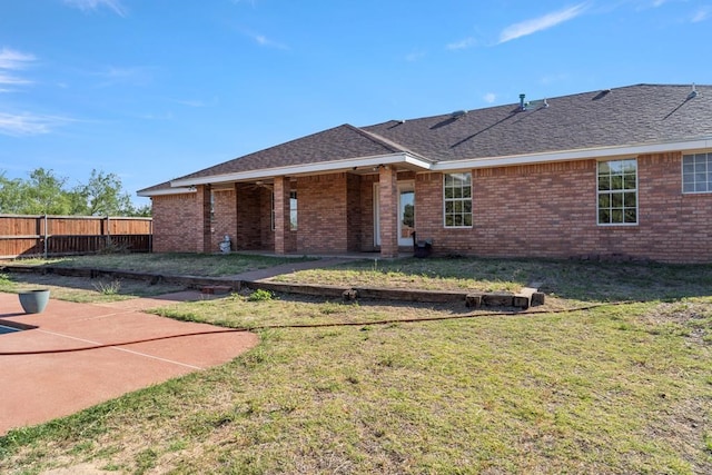 back of property featuring a patio and a lawn