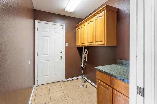 laundry area featuring light tile patterned flooring