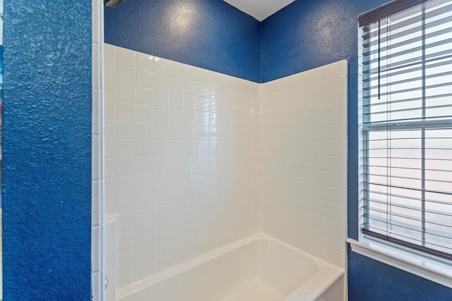 bathroom with washtub / shower combination