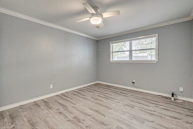 empty room with crown molding, baseboards, a ceiling fan, and wood finished floors