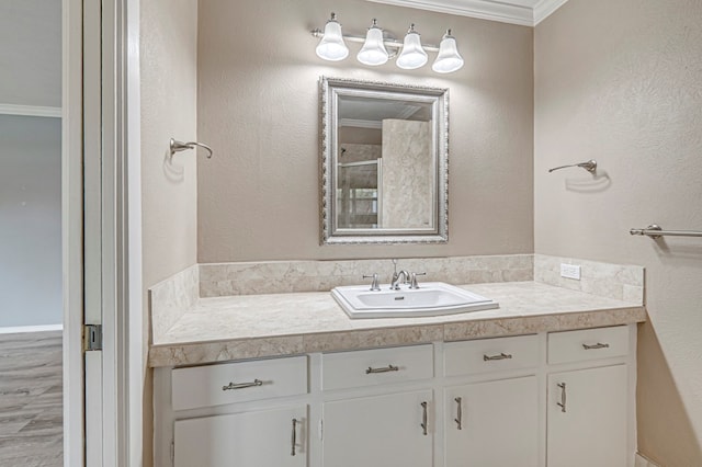 full bathroom featuring vanity, crown molding, and a shower