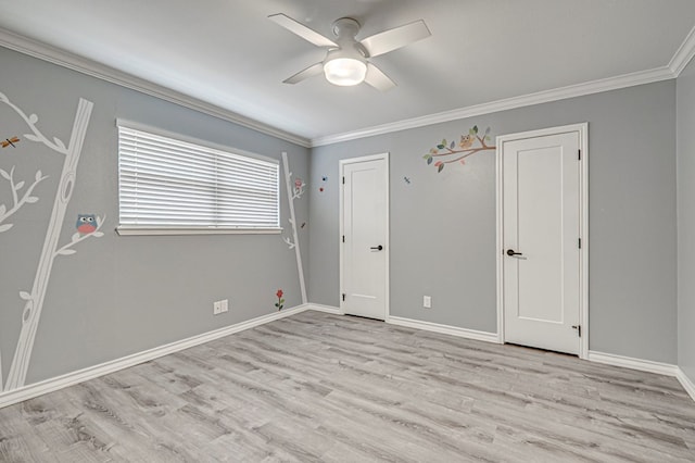 unfurnished bedroom with baseboards, ornamental molding, light wood-style flooring, and a ceiling fan
