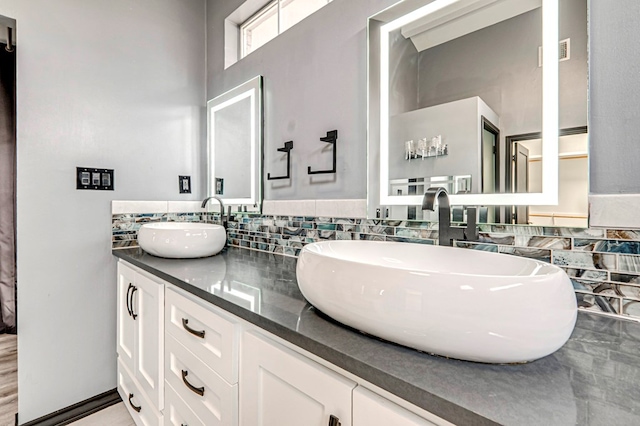 full bathroom with double vanity and a sink