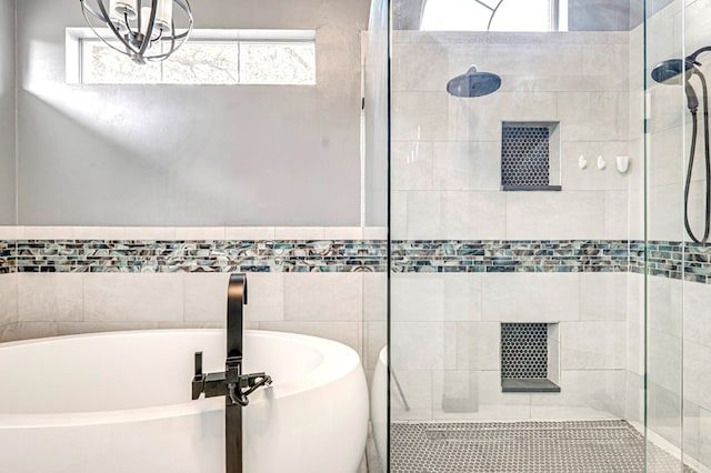 bathroom featuring a soaking tub and a stall shower