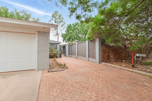 exterior space with fence and driveway