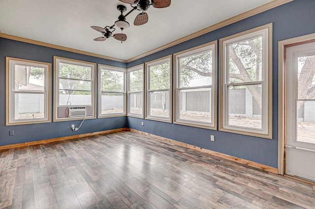 unfurnished room with crown molding, ceiling fan, cooling unit, baseboards, and wood finished floors