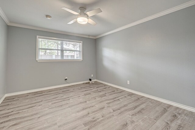 spare room featuring baseboards, ornamental molding, ceiling fan, and wood finished floors