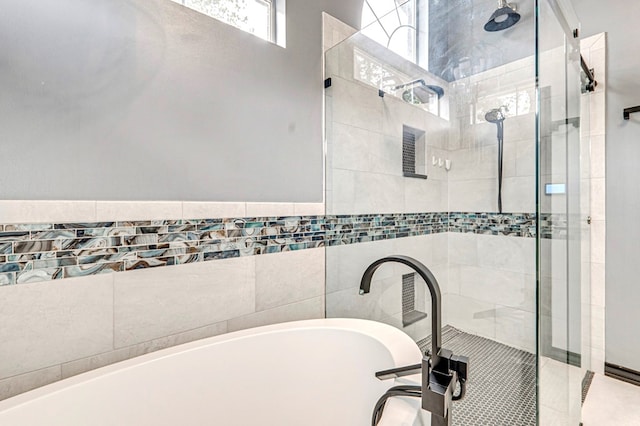 bathroom with a bathing tub and a shower stall